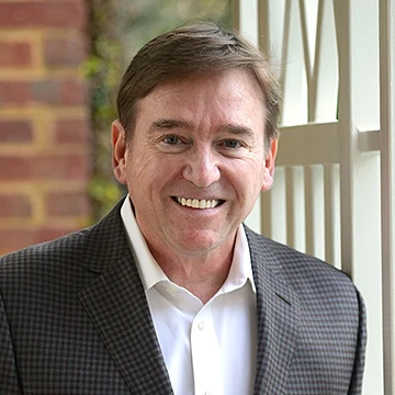 Person standing outdoors smiling