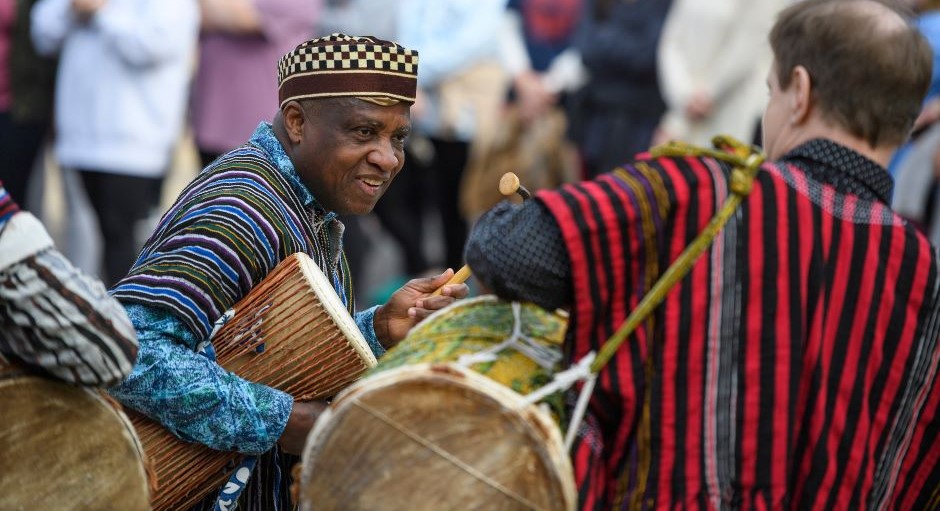 faculty member playing an African drum