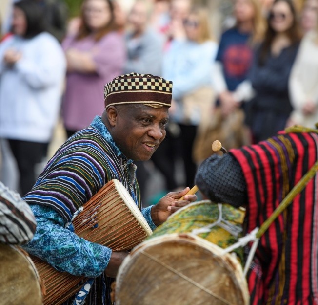 professor playing African drum