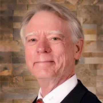 Person with gray hair smiling at camera