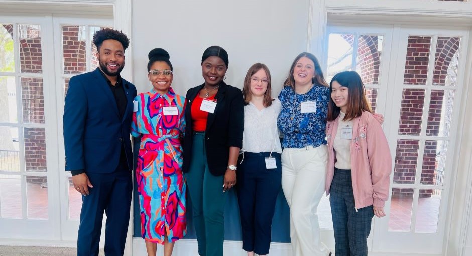 faculty member standing with a group of students