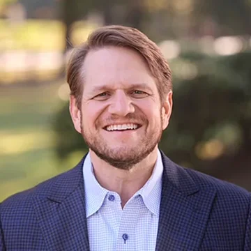 person smiling wearing jacket looking at camera