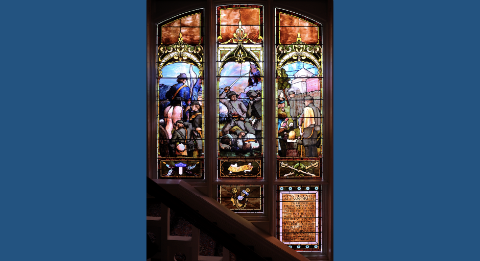 Colorful, arched, triptych stained glass showing a civil war battle. 