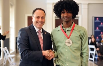 Student receiving an award from the dean