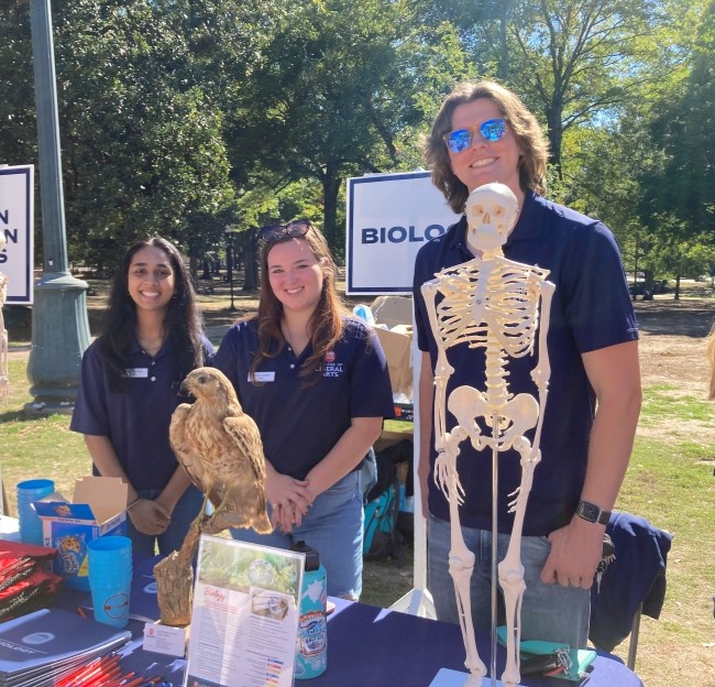 image of several students standing by a table