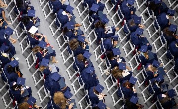 photo of many students seated at a graduation ceremony 