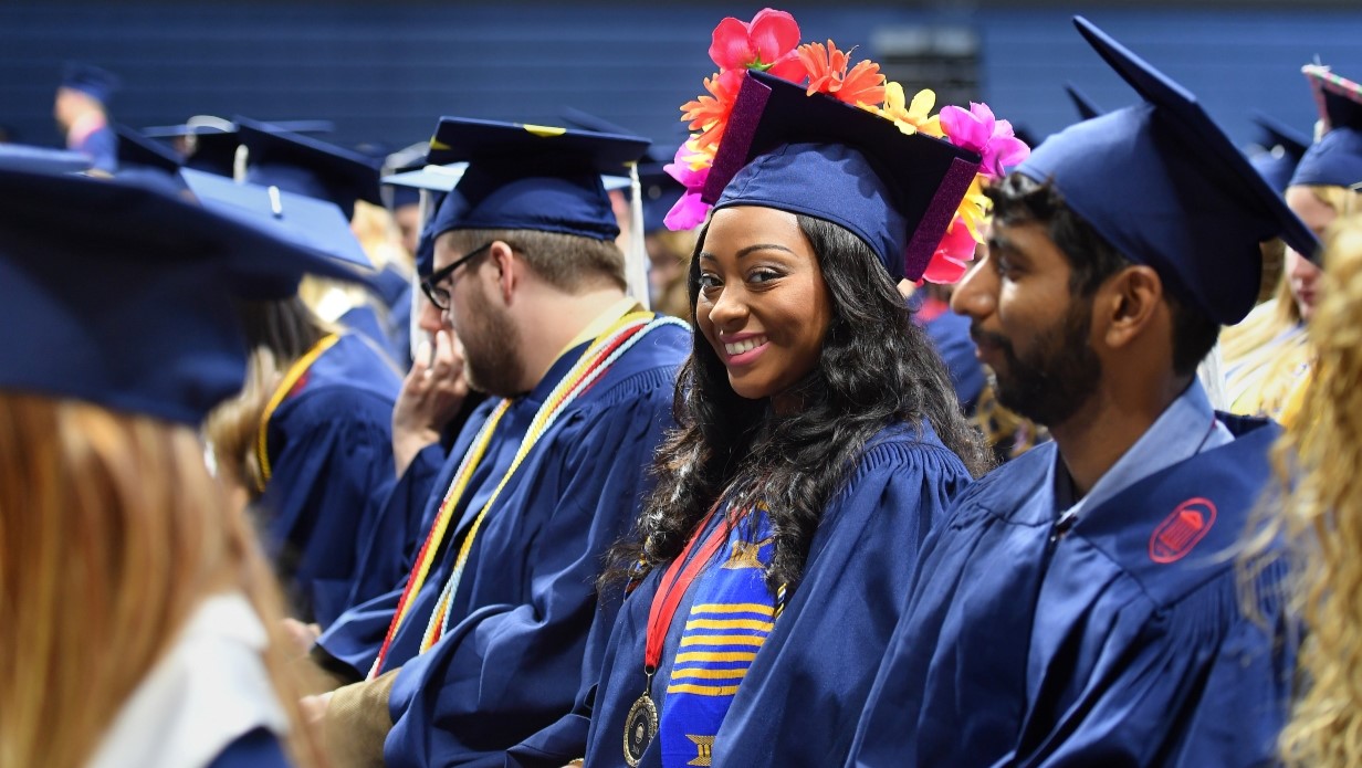 students in caps and gowns in a graduation ceremony 