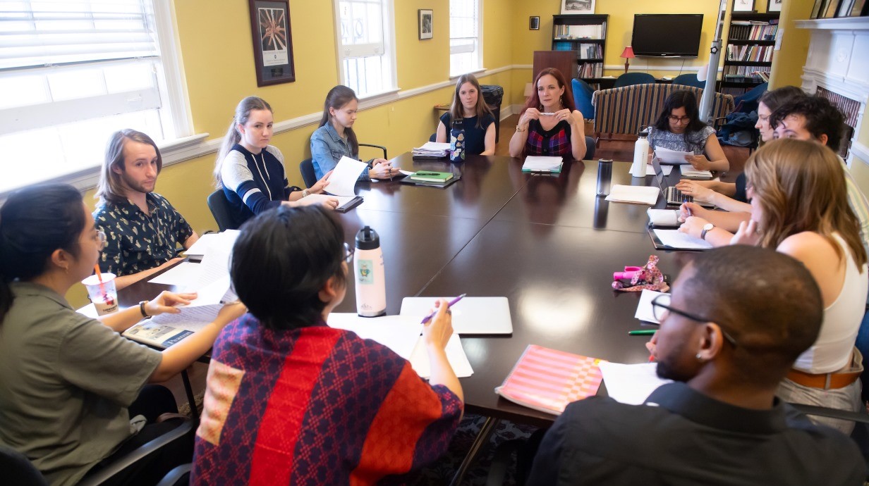 Group of creative writing students seated around a table in a seminar class