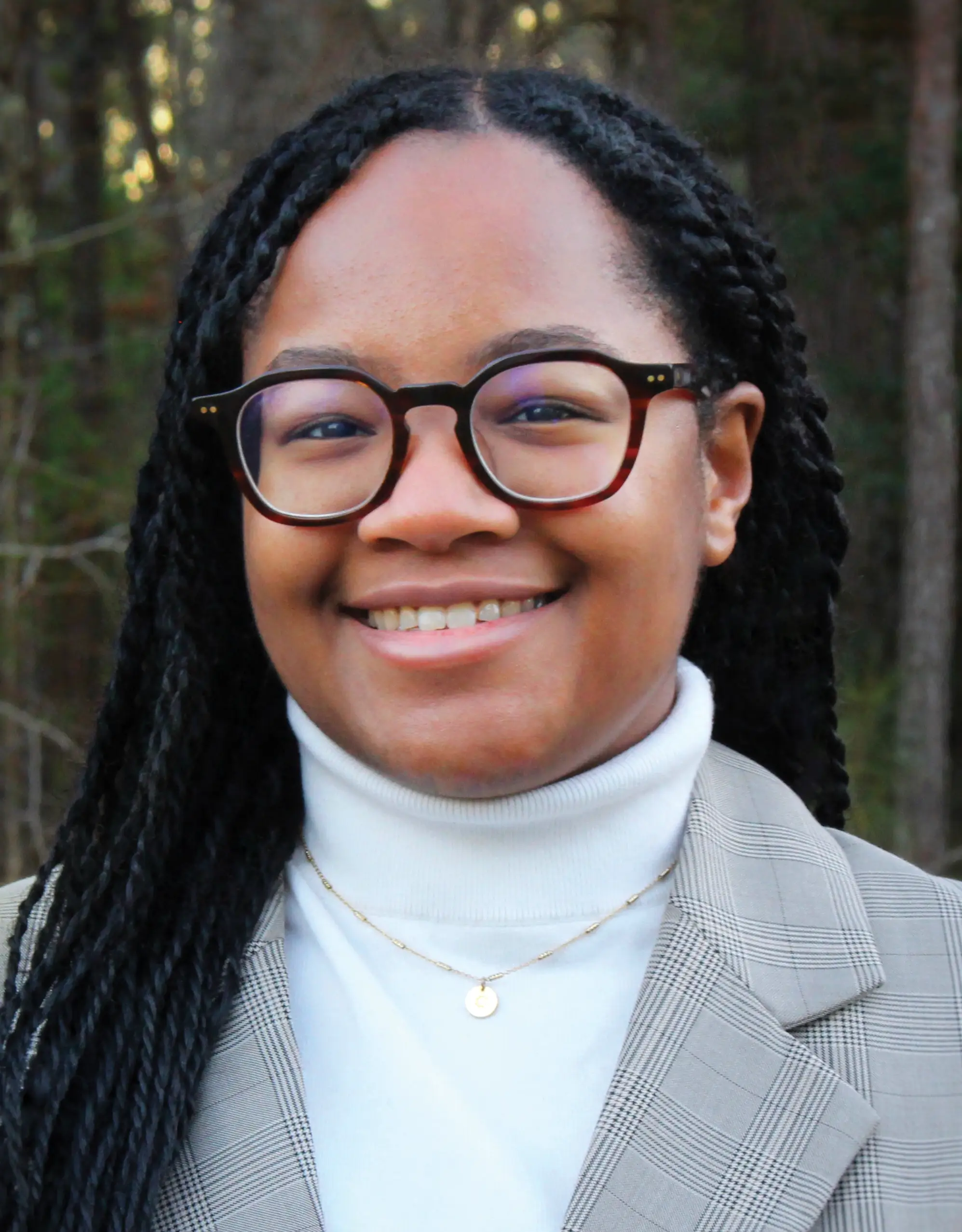 portrait of woman with glasses standing outside