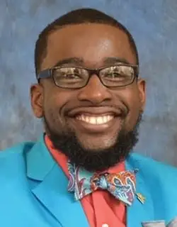 portrait of Bobby Hudson III wearing bowtie and smiling