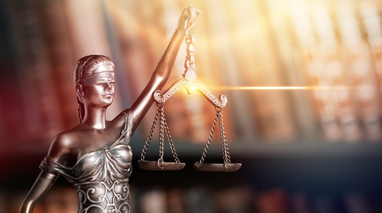 image of status holding scales of justice