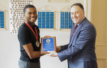 Student receiving an award from the dean