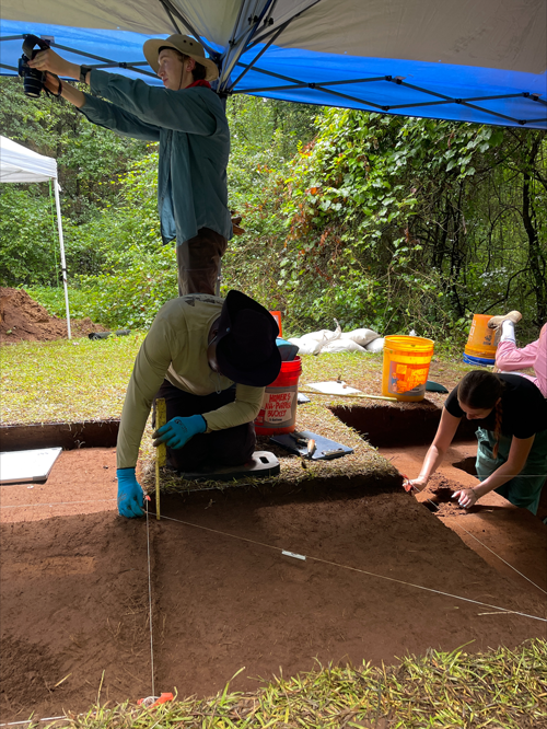 students measuring out dirt area and taking images