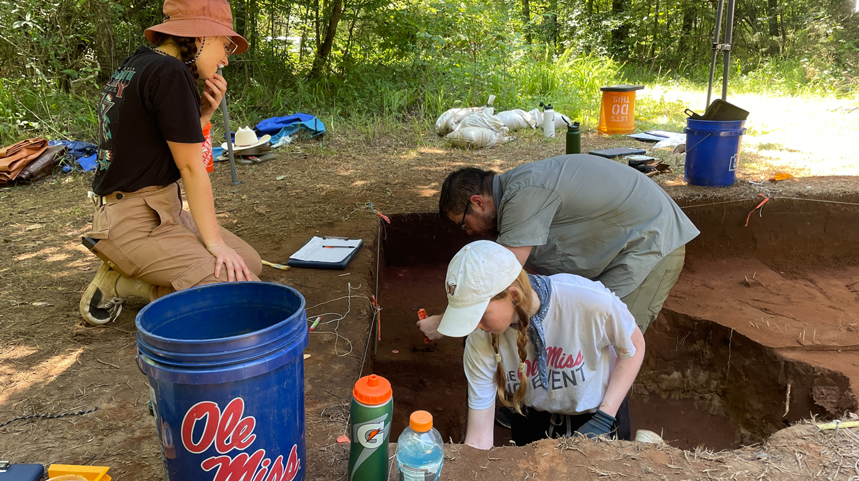 students digging in dirt and take samples