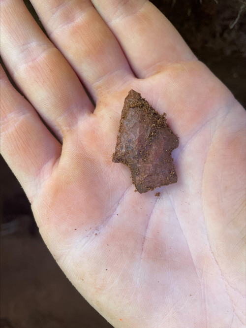 dirty arrowhead in hand