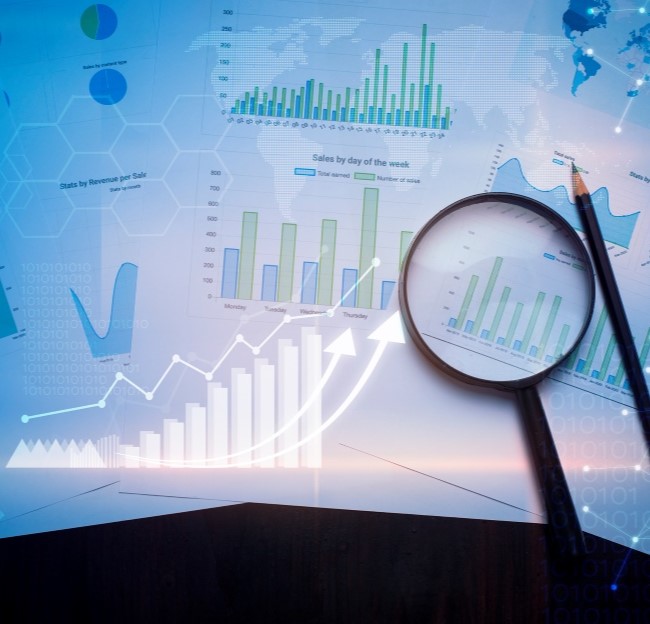 collage image of different ways to represent data such as line graphs or columns with a magnifying glass and pencil on top of the collage