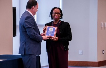 image of faculty member receiving award from the Dean