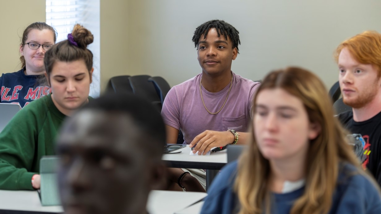 image of a small classroom with some graduate students 