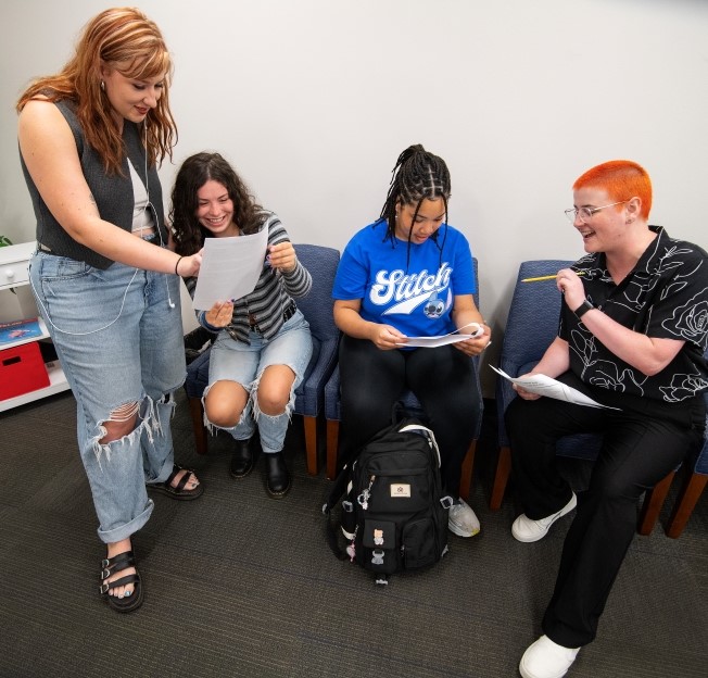 image of students and academic advisor in reception space for CLA Student Services 