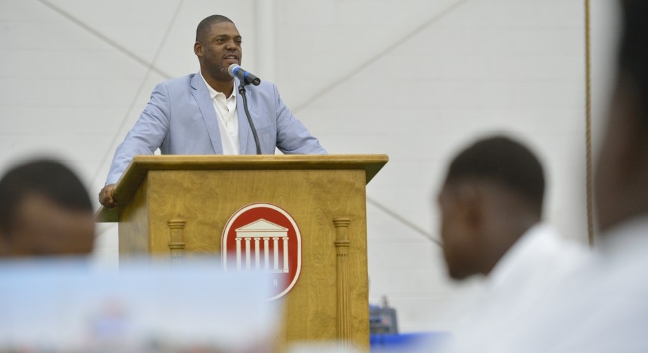 Image of Chuck Ross speaking at a podium