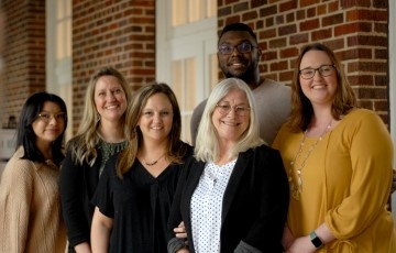 small group of staff members standing together