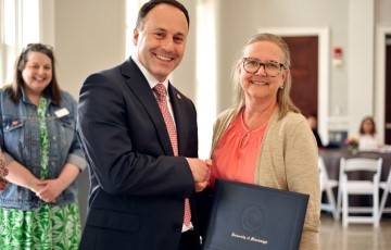 Staff member accepting an award from the Dean