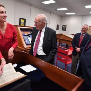 Jennifer Ford shows Shakespeare’s Second Folio to Jesse L. White, Associate Provost Noel Wilkin and Provost Morris Stocks. Photo by Kevin Bain/Ole Miss Communications