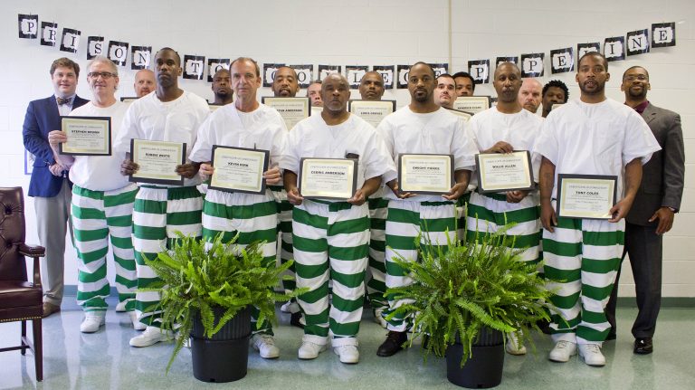 Co-directors Otis Pickett (back row, left) and Patrick Alexander (back row, right) with 16 graduates of the summer 2016 Prison-to-College Pipeline course at the Mississippi State Penitentiary. Submitted photo/Mississippi Department of Corrections