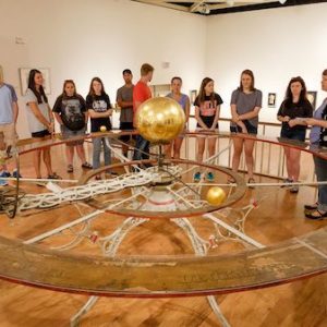 Students view Barlow’s Planetarium while on display at the UM Museum. Photo by Robert Jordan