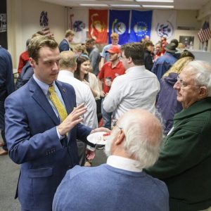 Andrew Newby (left), assistant director for Veteran and Military Services, speaks with guests at the opening of the Veterans Resource Center. Newby has implemented several new services that have helped Ole Miss rise in the rankings among public institutions for supporting military veteran students. Photo by Thomas Graning