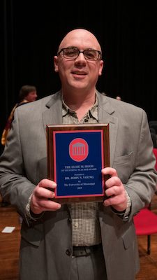 John Young shows off his plaque as the university’s 2019 Elsie M. Hood Teacher of the Year. Photo by Kevin Bain/Ole Miss