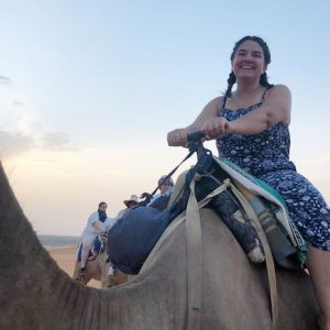 UM junior Isabel Spafford rides a camel in Morocco, where she spent her summer on an immersive experience of language and culture studies through the university’s Arabic Language Flagship Program.