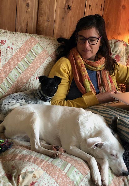 Melissa Ginsburg, a UM English professor, sits with her family dogs, Zimmy (center) and The Punisher. 