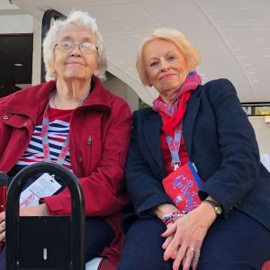 Millie Craig (left) and Barbara Beckmann enjoy a golf-cart tour of campus during the 2019 Texas A&M football weekend.