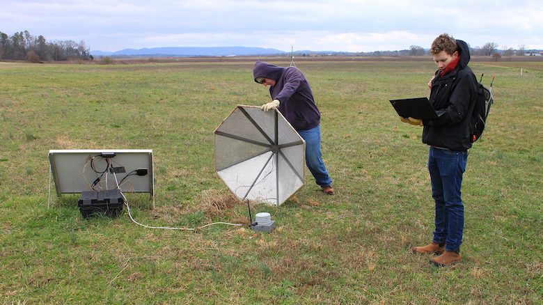 Brian Carpenter (left) and Hank Buchanan, two research and development engineers at the University of Mississippi’s National Center for Physical Acoustics, work on an infrasound array sensor at Alabama A&M University’s Winifred Thomas Agricultural Research Station north of Huntsville. Photo by Shea Stewart