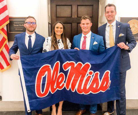 UM student veterans Winston Taylor (left), Lauren Graham and Jamie King show off an Ole Miss flag with Andrew Newby, UM assistant director for veterans and military services, in front of U.S. Rep. Trent Kelly’s office In Washington, D.C. The flag was originally carried to Iraq by King when he was deployed there with the U.S. Army’s 82nd Airborne Division. 