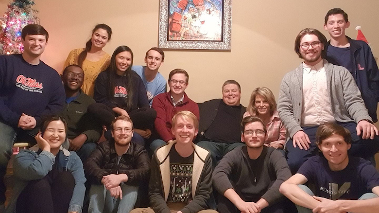 Adam Estes (back, right center) hosts a holiday dinner in 2019 for students in his saxophone studio. Submitted photo