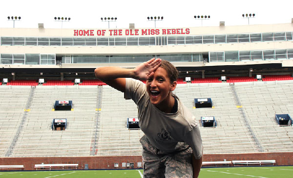 Megan Steis, a UM senior majoring in Chinese, celebrates being named a 2020 Navy Federal Credit Union Air Force ROTC All-American by showing off a landshark sign at Vaught-Hemingway Stadium. Photo by Avary Hewlett