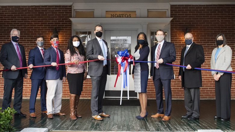 Andrew Newby (center left), assistant director for the Office of Veteran and Military Services, and Natasha Jeter (center right), vice chancellor for student affairs, cut the ribbon to the newly renovated VMS offices in George Street House. They are joined by (from left) Perry Sansing, Jamie King, Will Mobley, Stelenna Lloyd, Kyle Ellis, Provost Noel Wilkin and Cathy Baker. Photo by Logan Kirkland/Ole Miss Digital Imaging Services
