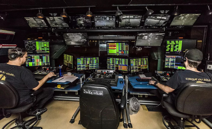 Wesley McClain (right), automation department supervisor for Cirque du Soleil’s ‘O’ works in the production’s automation control room during a performance in Las Vegas. Submitted photo