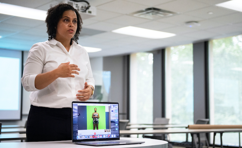 Elizabeth Moore, director of the UM Speaking Center, gives feedback on a presentation by student Leah Hughes, who is practicing a virtual presentation in front of a green screen. Photo by Logan Kirkland/Ole Miss Digital Imaging Services