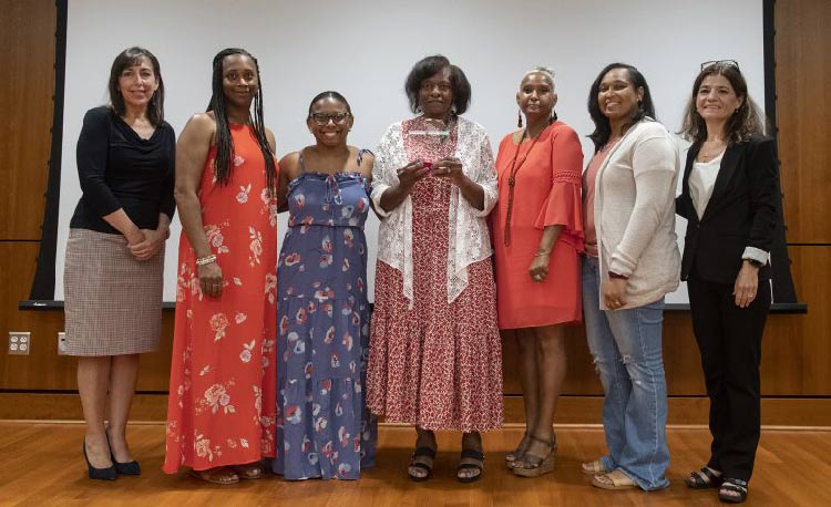 Laura Antonow, UM director of college programs (left), and Ginny Chavis (right), professor of art and interim associate provost, present the 2021 University of Mississippi Outstanding Internship Experience Partner of the Year to the family of Oscar Pope. They are (from second-to-left) Renada Ragsdale and Chelsea Dees, both of Richland; Beverly Pope, Oscar's mother, and Earnestine Mayes, both of Terry; and Shannon Lewis, of Richland.