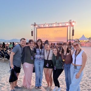 Pictured left to right: Will Jones, Megan Stewart, Zoe Frassinelli, Oanh Trieu, Justine Perrier, Julia Dent, Kaitlyn Steinroeder, led by Dr. Anne Quinney of the Modern Languages Department, attend a beach screening at the Cannes Film Festival in France. Photo by Will Jones