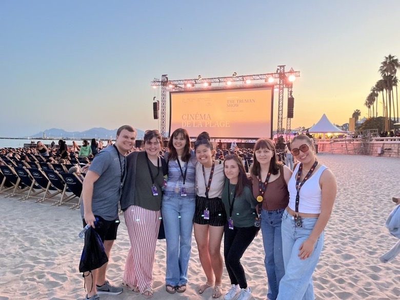 Pictured left to right: Will Jones, Megan Stewart, Zoe Frassinelli, Oanh Trieu, Justine Perrier, Julia Dent, Kaitlyn Steinroeder, led by Dr. Anne Quinney of the Modern Languages Department, attend a beach screening at the Cannes Film Festival in France. Photo by Will Jones