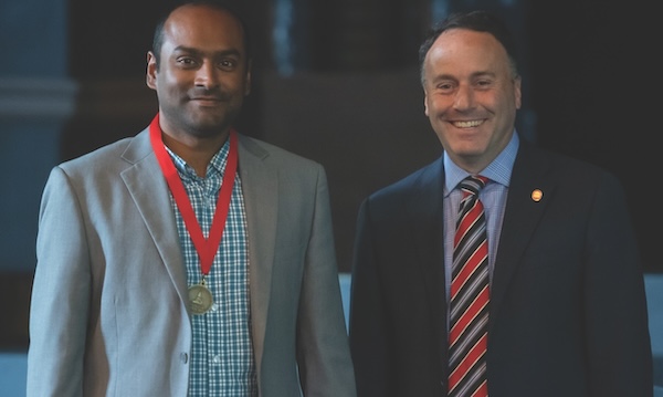 Saumen Chakraborty (left) receives the Dr. Mike L. Edmonds New Scholar Award in 2022 for achievements in research from Lee M. Cohen, dean of liberal arts. 